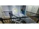 Stylish staircase featuring wooden steps and modern railings, bathed in natural light from a large window at 1033 Hawk Creek Trl, Lawrenceville, GA 30043