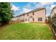 Spacious backyard with a manicured lawn and privacy fence, ideal for recreation and entertainment at 1076 Scenic Park Trl, Lawrenceville, GA 30046