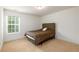 Bedroom featuring neutral carpet, one window and a bed with a dark comforter at 1076 Scenic Park Trl, Lawrenceville, GA 30046