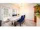 Inviting dining area with natural light, neutral walls, modern lighting, and seamless access to outdoor living at 1076 Scenic Park Trl, Lawrenceville, GA 30046