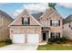 Charming two-story brick home featuring a two-car garage and well-maintained landscaping at 1076 Scenic Park Trl, Lawrenceville, GA 30046