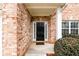 Close-up of the front door with brick facade and manicured shrubbery at 1076 Scenic Park Trl, Lawrenceville, GA 30046