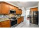 Updated kitchen featuring granite countertops, stainless steel appliances, tile backsplash, and hardwood cabinets at 1076 Scenic Park Trl, Lawrenceville, GA 30046