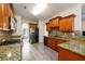 Updated kitchen featuring granite countertops, stainless steel appliances, tile backsplash, and hardwood cabinets at 1076 Scenic Park Trl, Lawrenceville, GA 30046