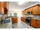 Updated kitchen featuring granite countertops, stainless steel appliances, tile backsplash, and hardwood cabinets at 1076 Scenic Park Trl, Lawrenceville, GA 30046