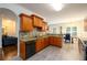 Updated kitchen featuring granite countertops, stainless steel appliances, tile backsplash, and hardwood cabinets at 1076 Scenic Park Trl, Lawrenceville, GA 30046