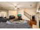 Spacious living room featuring a fireplace, hardwood floors, and staircase at 1076 Scenic Park Trl, Lawrenceville, GA 30046