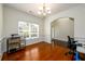 Bright office features hardwood floors, ample natural light from the large window, and stylish chandelier at 1076 Scenic Park Trl, Lawrenceville, GA 30046