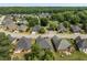 Aerial view showing rooftops and verdant tree cover across a well-maintained residential neighborhood at 115 Pinnacle Ln, Mcdonough, GA 30253