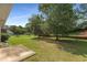 Large backyard with mature trees and partial fencing at 115 Pinnacle Ln, Mcdonough, GA 30253