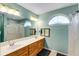 Well lit bathroom featuring a double sink vanity, updated lighting, and neutral toned walls at 115 Pinnacle Ln, Mcdonough, GA 30253