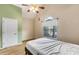 This bedroom features a large window, ceiling fan, neutral wall color, and closet at 115 Pinnacle Ln, Mcdonough, GA 30253