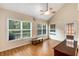 Bonus room area featuring hardwood floors, ample natural light, and ceiling fan at 115 Pinnacle Ln, Mcdonough, GA 30253