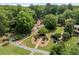 Scenic walking path and sitting area surrounded by a lush lawn, mature trees, and manicured shrubs at 115 Pinnacle Ln, Mcdonough, GA 30253
