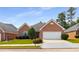 Charming brick home with manicured lawn, mature trees, and a two-car garage at 115 Pinnacle Ln, Mcdonough, GA 30253