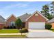 Charming single-story brick home featuring a two-car garage and well-maintained landscaping at 115 Pinnacle Ln, Mcdonough, GA 30253