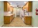 Traditional kitchen with light wood cabinets, white appliances, and neutral countertops, offering a functional cooking space at 115 Pinnacle Ln, Mcdonough, GA 30253