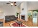 Warm living room with a fireplace, hardwood floors, and access to the dining area at 115 Pinnacle Ln, Mcdonough, GA 30253