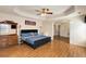 Spacious main bedroom featuring a tray ceiling, wood floors, and natural light, creating a welcoming retreat at 115 Pinnacle Ln, Mcdonough, GA 30253