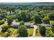 An aerial view showcases this beautiful home with lush surroundings, a long driveway, and mature trees at 385 Stonebridge Trl, Roswell, GA 30075