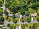 Overhead view of a well-maintained property featuring a green lawn and mature trees at 385 Stonebridge Trl, Roswell, GA 30075
