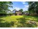 Spacious backyard with lush green grass, mature trees, and a playset at 385 Stonebridge Trl, Roswell, GA 30075
