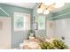 Well-lit bathroom with a granite countertop sink, white tiled backsplash, and green accent walls at 385 Stonebridge Trl, Roswell, GA 30075