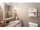 Half-bath features granite countertop, decorative shelving, and ample space at 385 Stonebridge Trl, Roswell, GA 30075