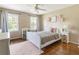 Bedroom with wood floors, pink rug, ceiling fan, and white furniture and decor at 385 Stonebridge Trl, Roswell, GA 30075