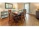 A charming dining area features a wood table with hardwood floors and natural light at 385 Stonebridge Trl, Roswell, GA 30075