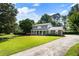 A lovely two-story home boasts a manicured lawn, a long drive, and mature trees in a serene setting at 385 Stonebridge Trl, Roswell, GA 30075