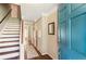 Bright foyer with hardwood floors, staircase, and blue front door at 385 Stonebridge Trl, Roswell, GA 30075