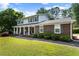 Traditional home with a welcoming covered porch, brick accents, and well-maintained landscaping at 385 Stonebridge Trl, Roswell, GA 30075