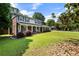 Traditional two-story home featuring a welcoming front porch and well-manicured lawn at 385 Stonebridge Trl, Roswell, GA 30075