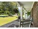 Inviting front porch with rocking chairs, hanging flowers, and a view of the well-manicured lawn at 385 Stonebridge Trl, Roswell, GA 30075