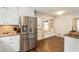 Bright kitchen features stainless steel refrigerator, granite countertops and a cozy breakfast nook with window seat at 385 Stonebridge Trl, Roswell, GA 30075