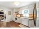 White kitchen featuring stone countertops and stainless steel appliances at 385 Stonebridge Trl, Roswell, GA 30075