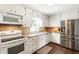 Kitchen with white cabinets, granite countertops, and stainless steel appliances at 385 Stonebridge Trl, Roswell, GA 30075