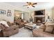 Cozy living room with a brick fireplace, comfortable seating, and neutral decor at 385 Stonebridge Trl, Roswell, GA 30075