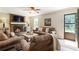 Cozy living room featuring a brick fireplace, plush seating, and bright windows at 385 Stonebridge Trl, Roswell, GA 30075