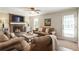 Cozy living room with brick fireplace, tv, and comfortable seating at 385 Stonebridge Trl, Roswell, GA 30075