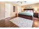 Well-lit bedroom with large bed, hardwood floors, and plentiful storage space at 385 Stonebridge Trl, Roswell, GA 30075