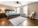 Spacious bedroom with hardwood floors, natural light, and comfortable furnishings at 385 Stonebridge Trl, Roswell, GA 30075