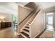 Hallway features hardwood floors and a staircase leading to the upper level at 385 Stonebridge Trl, Roswell, GA 30075