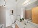 Bathroom features a large mirror, a ceramic sink, and a tiled tub with shower at 1344 Fernwood Ne Cir, Brookhaven, GA 30319