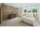 Sun-filled bedroom with a brick wall, large window and tree views, creating a serene retreat at 1344 Fernwood Ne Cir, Brookhaven, GA 30319