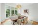 Bright dining room featuring a large window, hardwood floors, and contemporary decor at 1344 Fernwood Ne Cir, Brookhaven, GA 30319