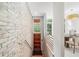 Bright entryway with a wooden door, brick wall, and stairs leading to the main living area at 1344 Fernwood Ne Cir, Brookhaven, GA 30319