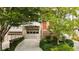 Townhome exterior with a driveway, a brick staircase, and a garage with a neutral-colored door at 1344 Fernwood Ne Cir, Brookhaven, GA 30319
