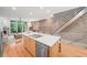Modern kitchen features stainless steel appliances, central island, and hardwood flooring at 1344 Fernwood Ne Cir, Brookhaven, GA 30319